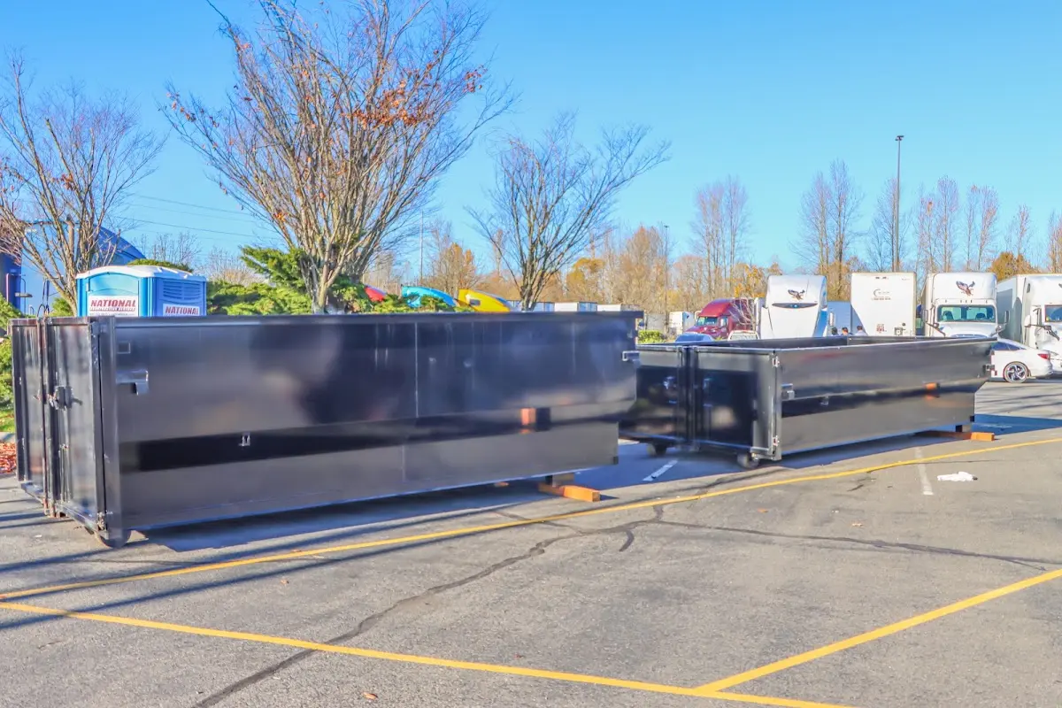 Professional dumpster rental service with roll-off container on residential driveway in Glen Burnie